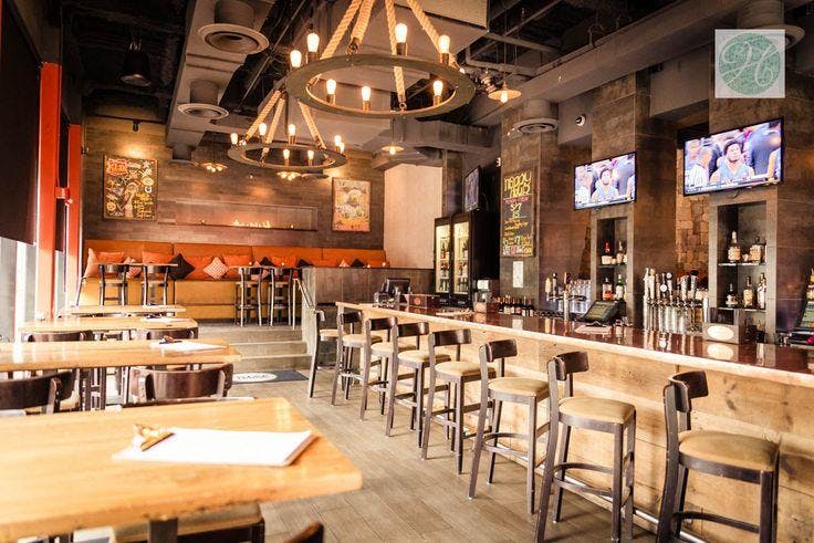 Modern bar at City Tap House with warm lighting, ideal for casual events and gatherings.