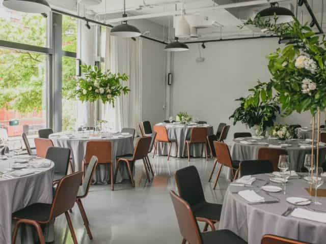 Sophisticated event space in Eaton DC with elegant gray tables and floral centerpieces.