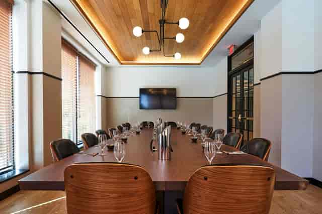 Modern conference room in Eaton DC with a long wooden table, perfect for formal meetings.
