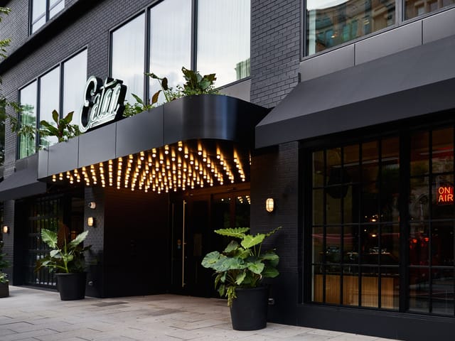 Modern venue entrance with stylish lighting and greenery for upscale events in Eaton DC.