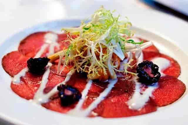 Fine dining carpaccio dish at The Occidental, showcasing culinary aesthetics for events.