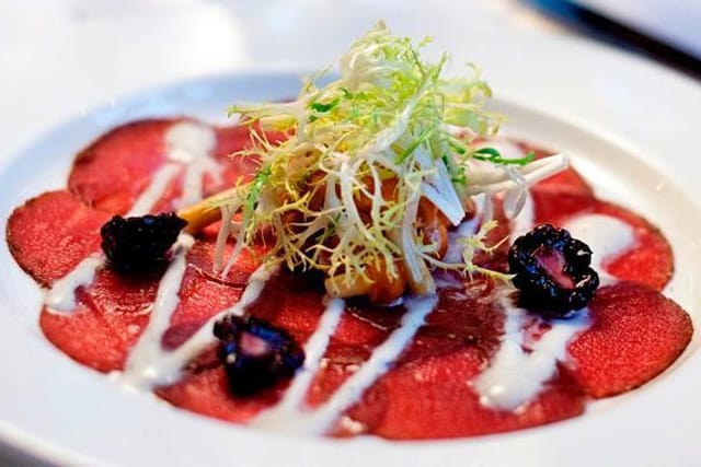 Fine dining carpaccio dish at The Occidental, showcasing culinary aesthetics for events.