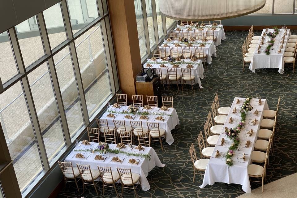 Sky Ballroom at Topgolf D.C. with elegant tables for events and natural light ambiance.