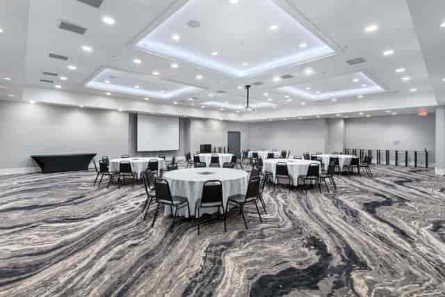 Sky Ballroom at Topgolf D.C. with round tables, perfect for conferences and events.