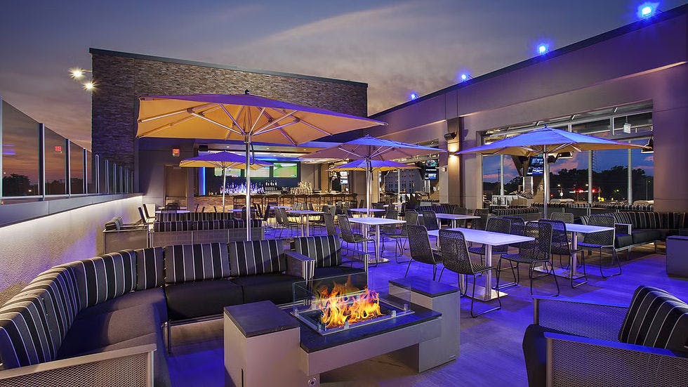 Stylish rooftop venue at Topgolf D.C. with vibrant lighting for events and parties.