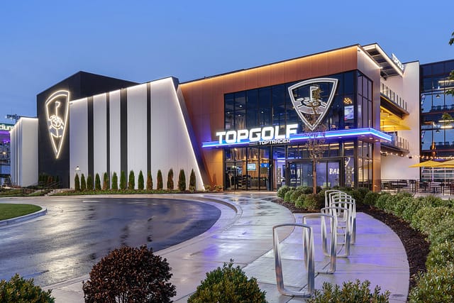 Chairman's Suite at Topgolf D.C. with vibrant lighting for corporate events and gatherings.
