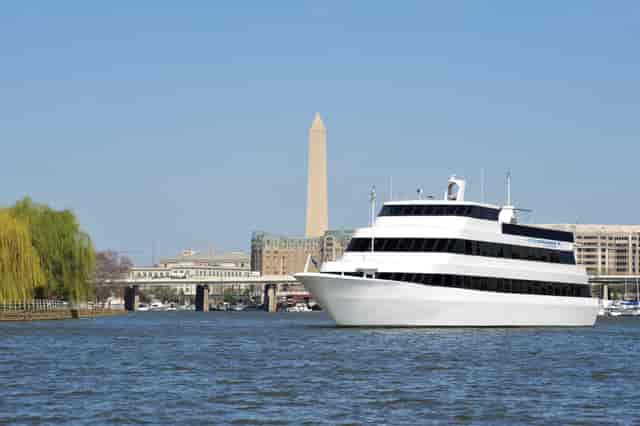 Sleek event cruise ship with Washington Monument, ideal for corporate gatherings and receptions.