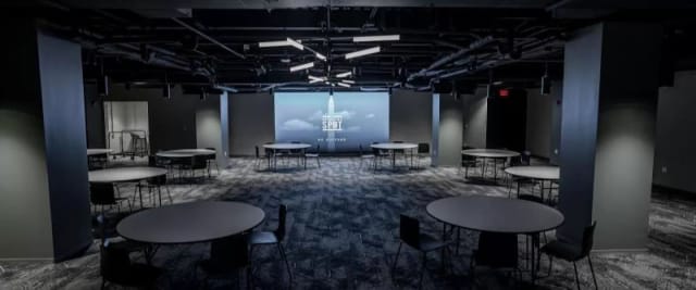 Private workspace with round tables for corporate meetings and workshops.