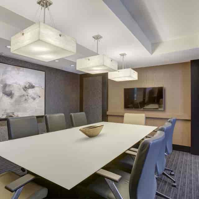 Modern conference room with sleek table, ideal for professional meetings and presentations.
