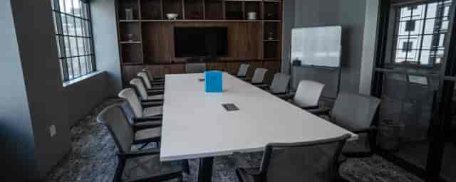 Modern Caucus Conference room with sleek table, ideal for meetings and workshops.