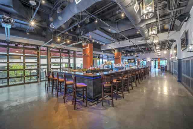 Spacious modern dining room with stylish bar for networking events and social gatherings.