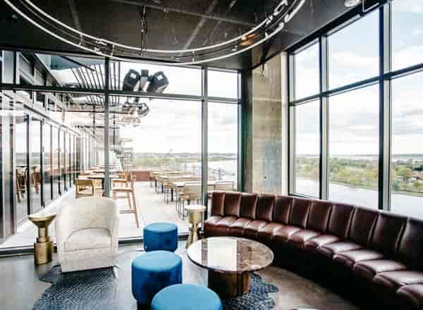 Modern meeting room with large windows, ideal for networking and social gatherings.