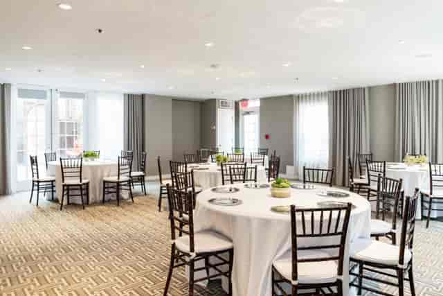 Brabo Private Dining Room in Archer Hotel Alexandria, elegant meeting space with round tables.