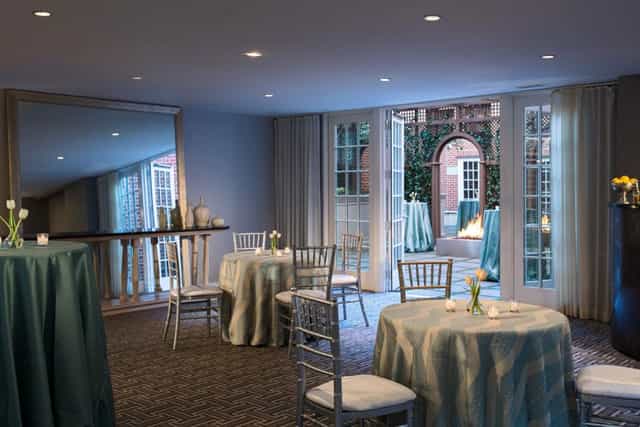 Elegant event space with round tables and chiavari chairs at Archer Hotel Alexandria.