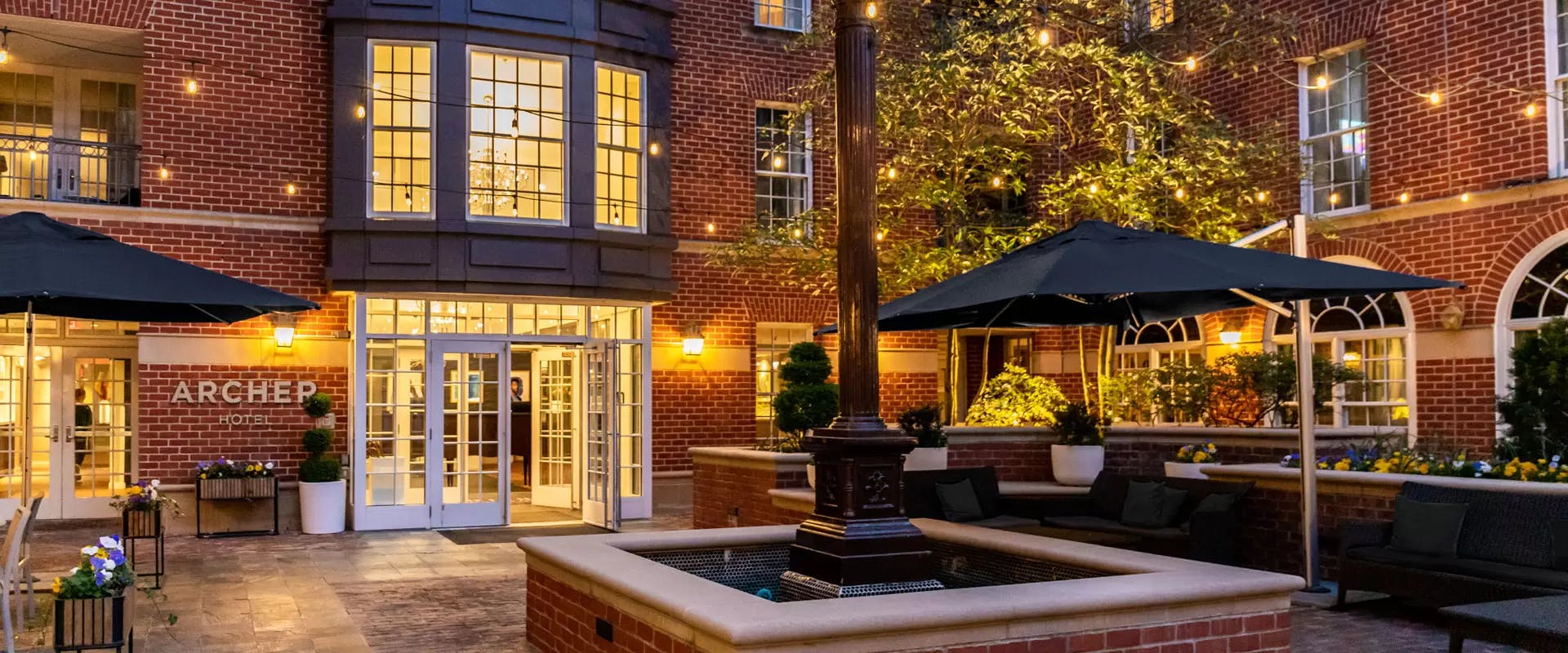 Charming outdoor restaurant venue with elegant lighting for events in Archer Hotel Alexandria.