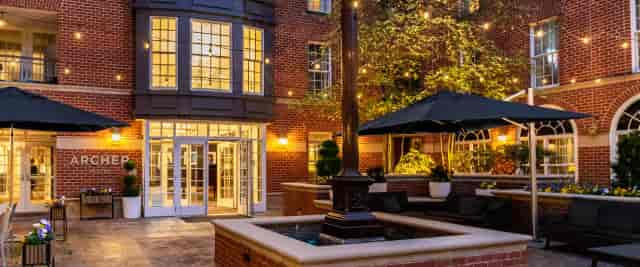 Charming outdoor restaurant venue with elegant lighting for events in Archer Hotel Alexandria.