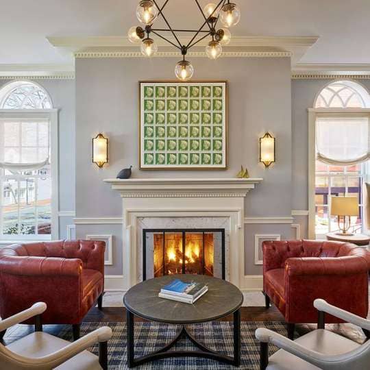 Cozy meeting room with leather chairs and fireplace in Morrison House, Alexandria.