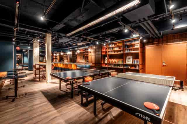 Modern sports bar with ping pong tables, perfect for casual meetings and social events.