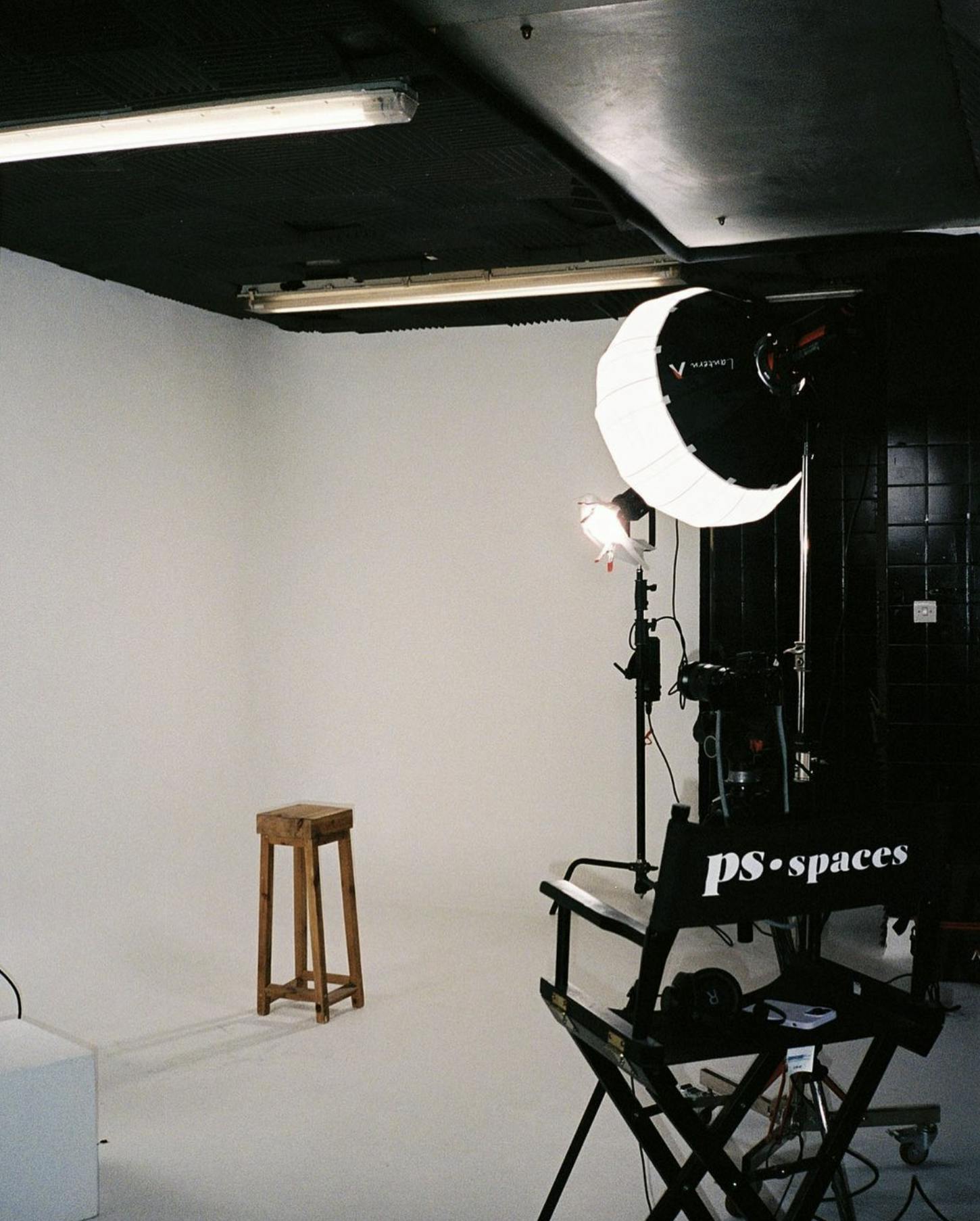 Minimalist photo studio setup with focused lighting for professional shoots and events.