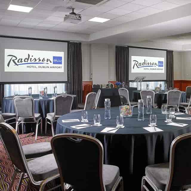 Meeting room at Radisson Blu Dublin Airport, featuring round tables for corporate events.