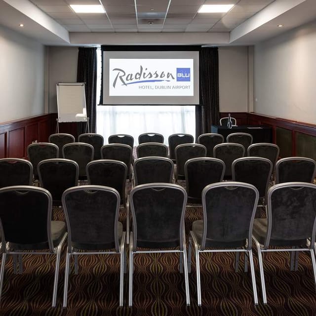 Meeting room at Radisson Blu Dublin Airport, featuring a presentation screen for corporate events.