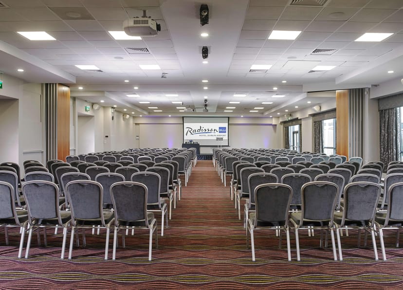 Conference room at Radisson Meetings with grey chairs for events and presentations.