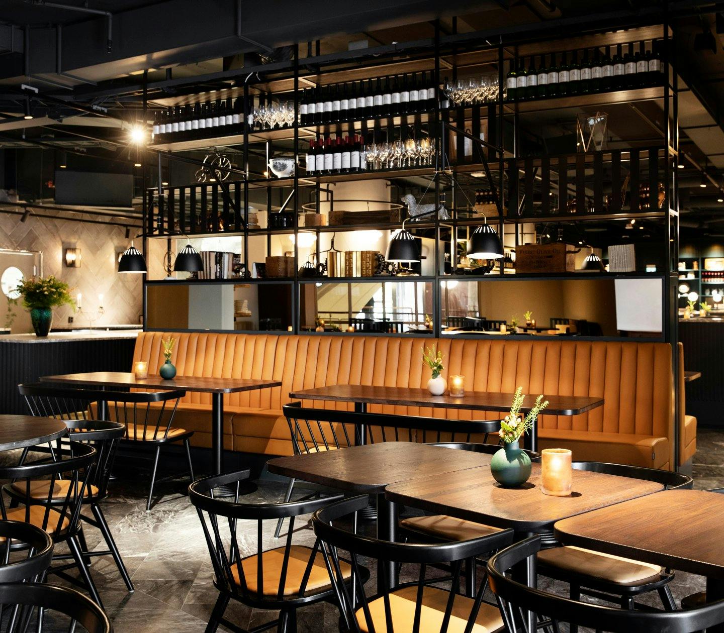 Modern restaurant interior with leather seating, ideal for networking events and dinners.