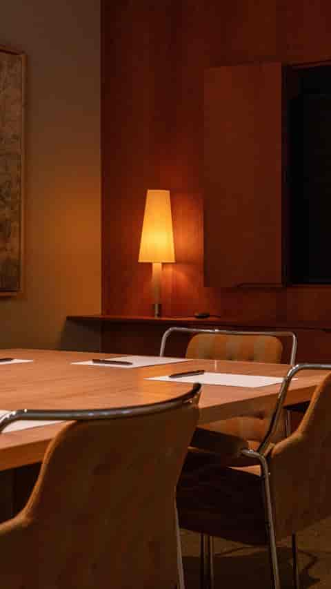 Ruth in Miss Clara by Nobis, modern meeting room with polished wooden table for collaboration.