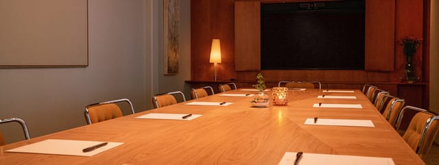 Ruth in a warm wood meeting room, perfect for productive discussions and events.