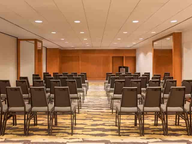 Versatile meeting space with rows of chairs at Sheraton Stockholm for workshops and presentations.