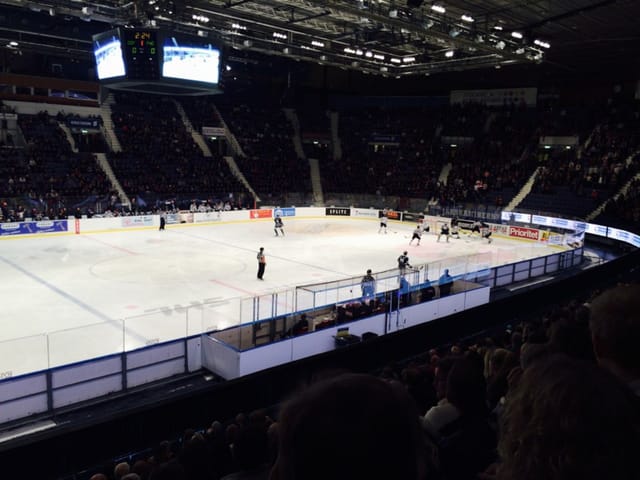 Ice skating rink at Hovet Arena during an engaging ice hockey game, perfect for events.