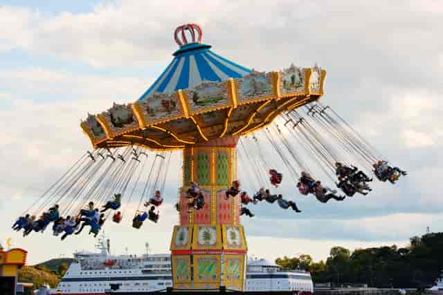 Vibrant swing ride at Gröna Lund amusement park for exciting event entertainment.