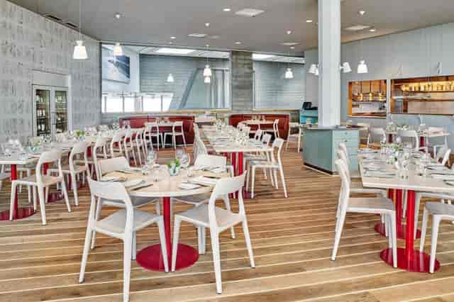 Modern Artipelag Restaurant with round tables, perfect for events and gatherings.