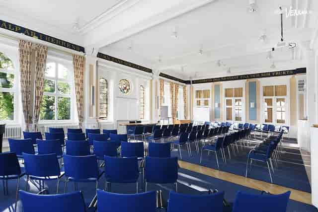 Event space at Ersta Conference with blue chairs, ideal for meetings and workshops.