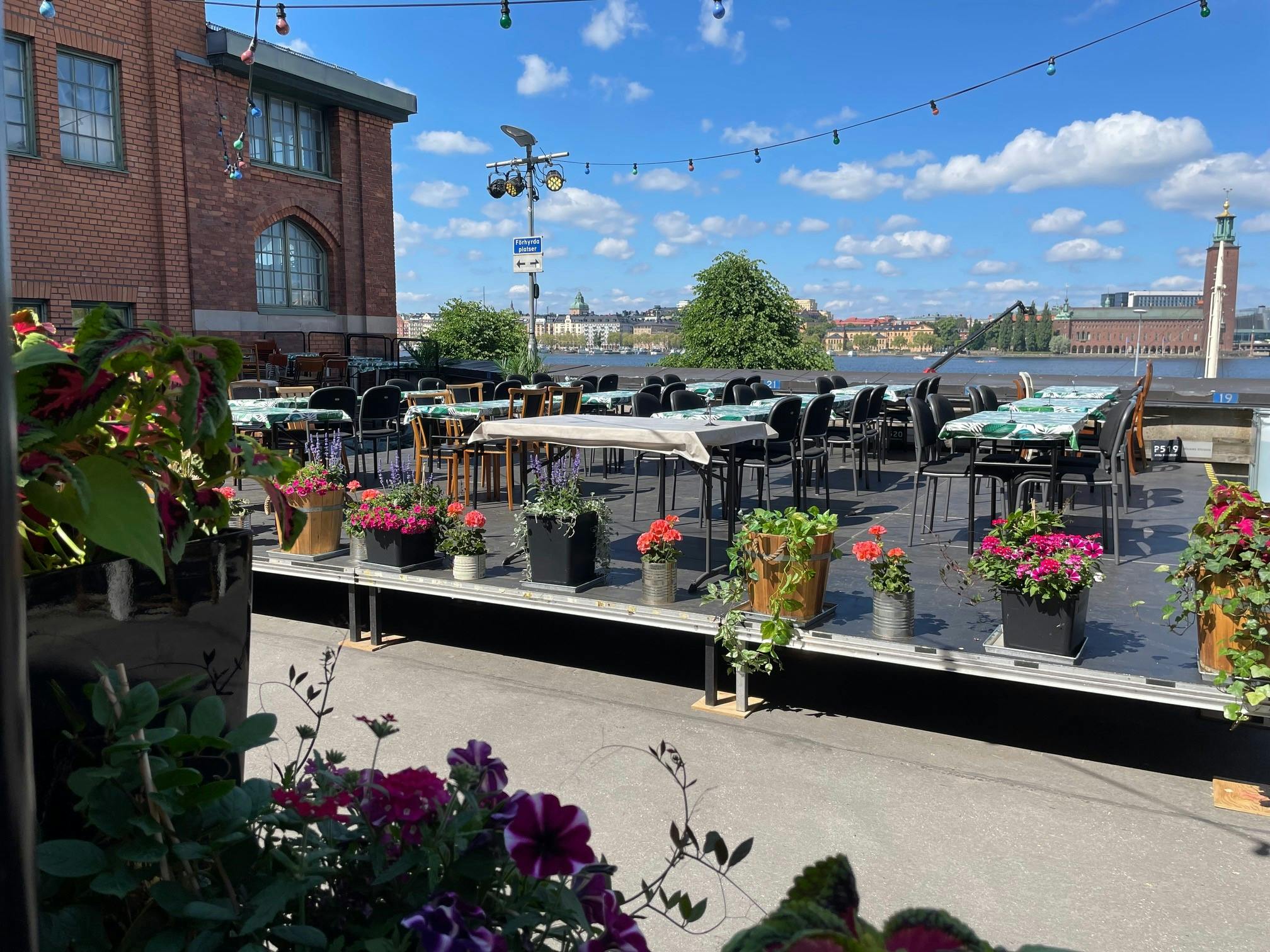 Charming outdoor event space at Münchenbryggeriet with vibrant flowers, ideal for gatherings.