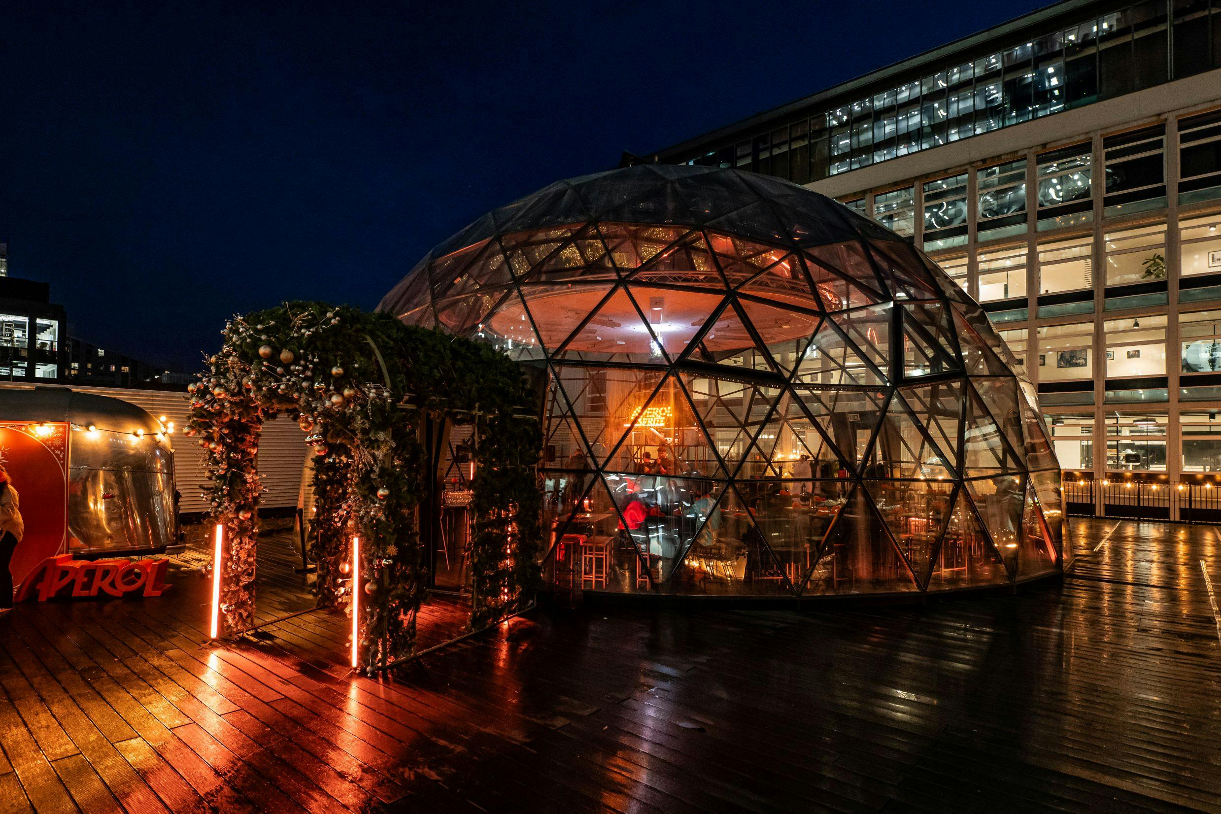 Winter Oasis geodesic dome venue, illuminated for elegant events and intimate gatherings.