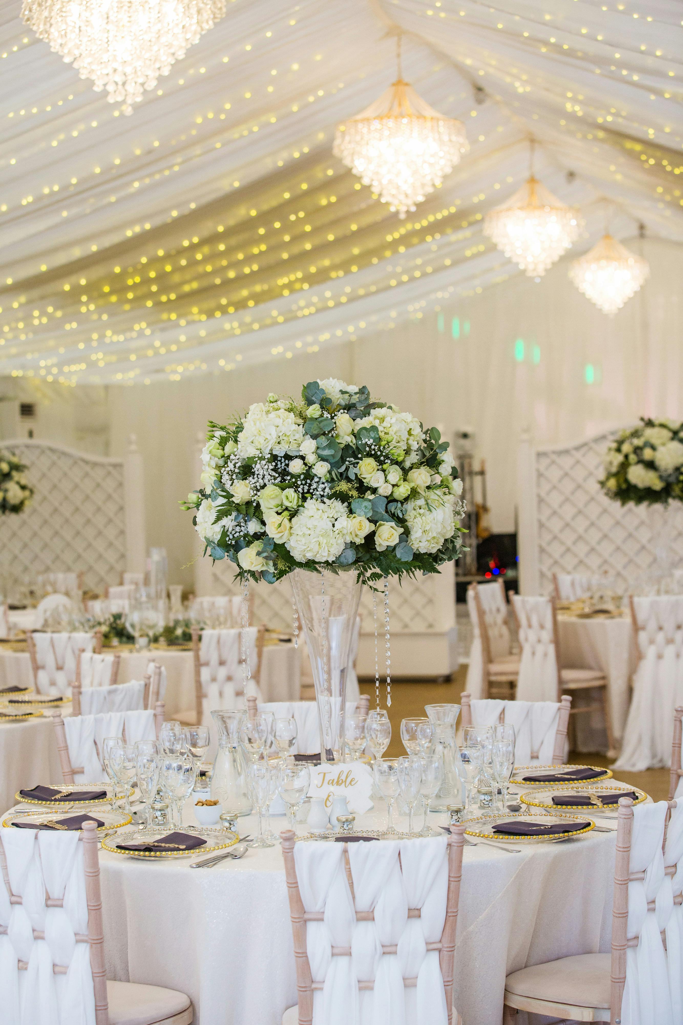 Elegant Pavilion at Quendon Hall with floral centerpieces for weddings and events.