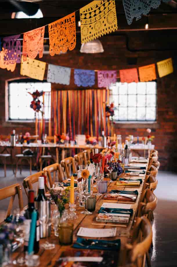 Banquet table with floral centerpieces at The Stables wedding venue, perfect for events.
