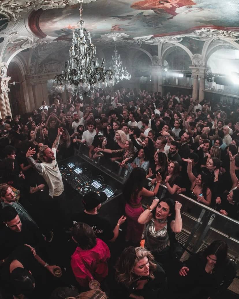 Vibrant nightclub scene at Café Opera with live DJ, perfect for events and entertainment.