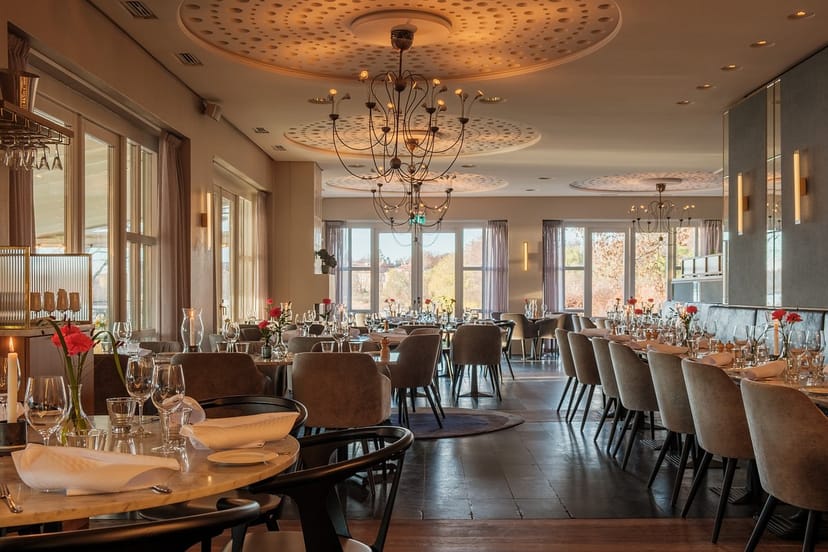 Elegant restaurant interior with soft lighting, ideal for corporate dinners and events.
