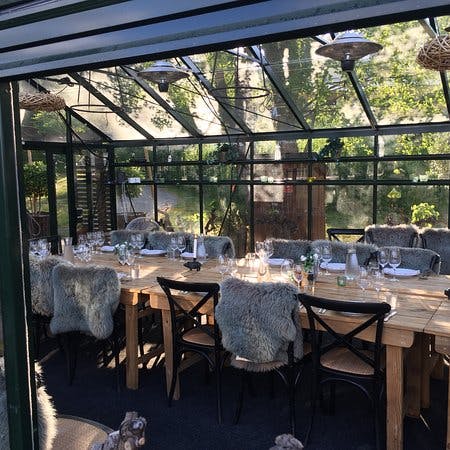 Elegant greenhouse dining at Orangeriet, perfect for intimate gatherings and retreats.