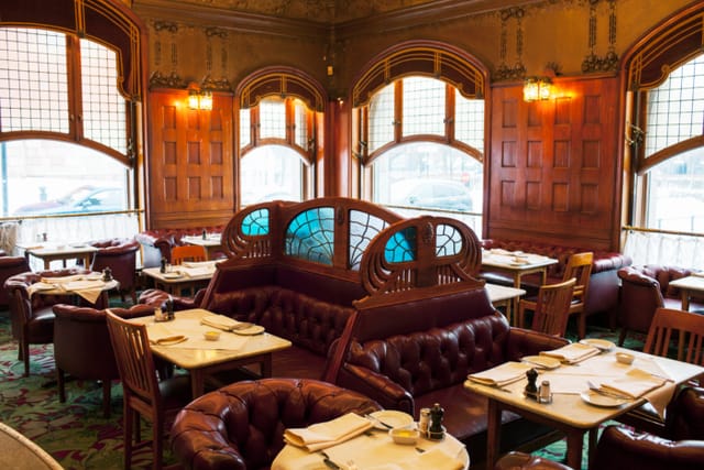 Elegant restaurant interior with wooden paneling, ideal for corporate events and private dining.