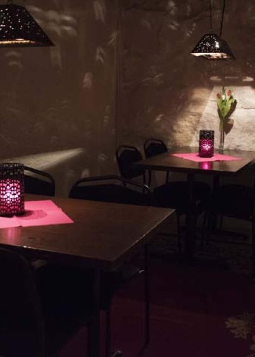 Intimate event space with candles at Hoppborg, Källaren Peder Muur for networking gatherings.