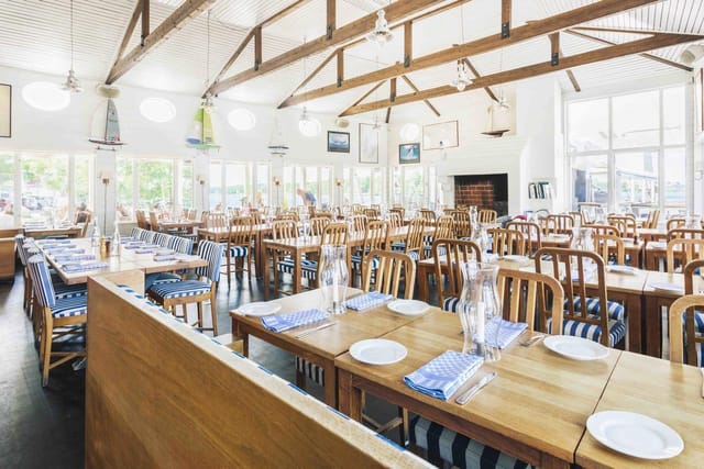Spacious banquet hall with nautical decor, perfect for events and gatherings.