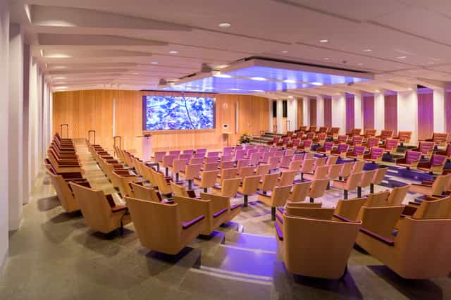 Modern auditorium with tiered seating for conferences and corporate events.