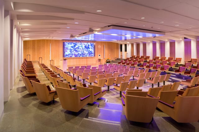 Modern auditorium with tiered seating for conferences and corporate events.