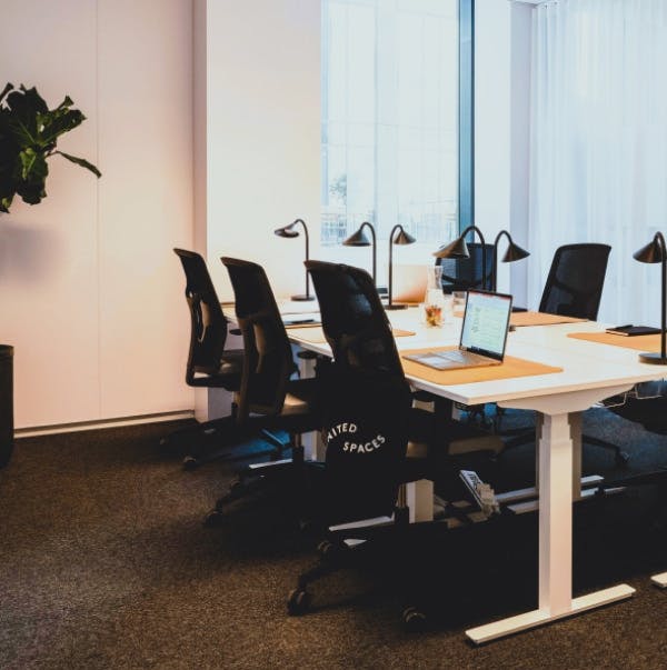 Modern recording studio meeting room with sleek table, ideal for presentations and collaboration.