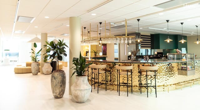 Modern lounge with gold accents, perfect for networking events and casual meetings.