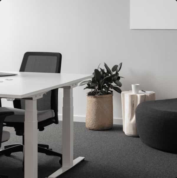 Modern private office with sleek white table, ideal for collaborative meetings and brainstorming.
