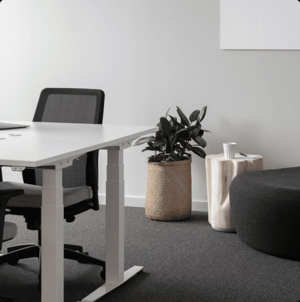 Modern private office with sleek white table, ideal for collaborative meetings and brainstorming.